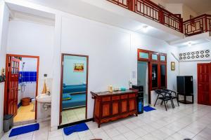 a bathroom with a sink and a desk in a room at Lestari Malioboro Guesthouse in Sentool