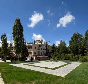 a park with a building in the background at Mon Refuge 111-110 in Bcharré