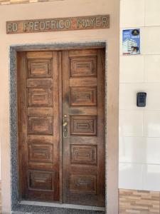 a wooden door in a building with a sign above it at Apartamento central in Domingos Martins