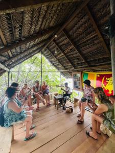 a group of people sitting on benches in a building at Sky and Sand Guesthouse in Beruwala