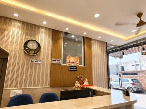 a meeting room with a clock on the wall at Hotel Shree Vrindavan Inn in Vrindāvan