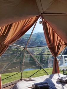 a room with a bed and a large window at Drivibe Glamping, Goražde in Goražde