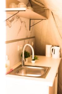 a kitchen sink in a small room with at Drivibe Glamping, Goražde in Goražde