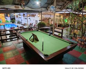 a pool table sitting in a room with a pool table at St. John Island View Pensionne in El Nido