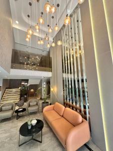 a lobby with a couch and chairs in a building at Kızılkaya Business Otel in Korfez