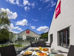 a table with plates of food on a patio at ibis Plymouth in Plymouth