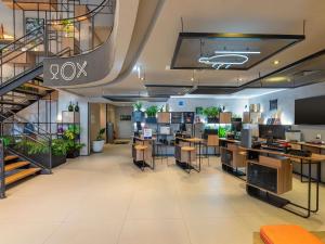 an office with a staircase and tables and chairs at ibis Sao Paulo Barra Funda in São Paulo