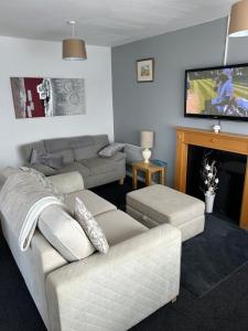 a living room with a couch and a tv at Chestnut 3 in Mablethorpe