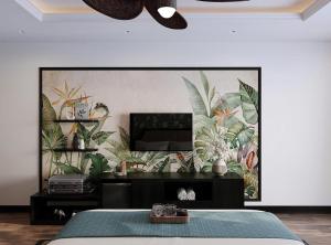 a bedroom with a wall with a mural of plants at Nature Resort Vangvieng in Vang Vieng
