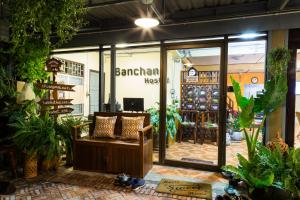 a store front with a bench and plants at Banchan Hostel in Phra Nakhon Si Ayutthaya