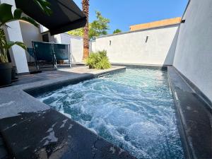 a swimming pool in the middle of a house at SiRiuS rooms & charme in Villasimius