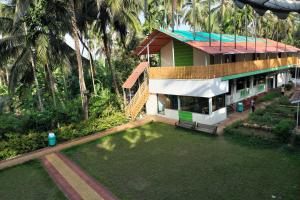 an aerial view of a house with a yard at Betel Leaf Resort in Māhīm