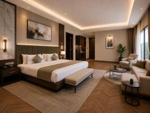 a bedroom with a large bed and a living room at Airport Hotel Vella VILLA By Corporate Group Delhi IGI Airport Terminal 3 With Free Airport Pickup in New Delhi