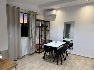 a dining room with two tables and chairs and a window at Rent Room Albano in Vlorë +22 photos