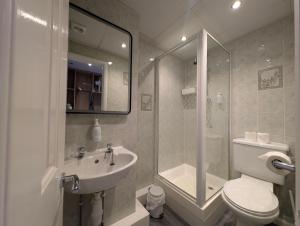 a bathroom with a toilet and a sink and a shower at Graham Arms Inn in Longtown +137 photos