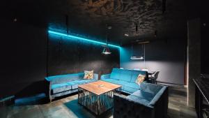 a living room with a blue couch and a table at Mycelio Atlantic Residence with Atlantic View in Ribamar