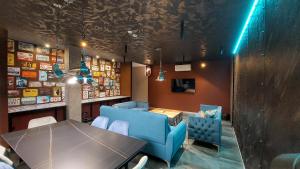 a dining room with a table and a blue couch at Mycelio Atlantic Residence with Atlantic View in Ribamar