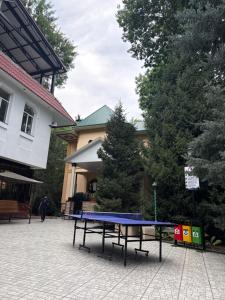 a ping pong table in front of a building at Oqtoshsoy in Oqtosh