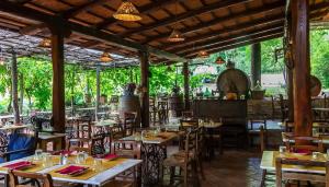 a restaurant with tables and chairs in a room at Hotel Sor Paolo in San Casciano in Val di Pesa