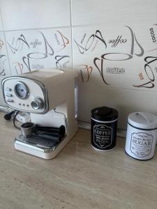 a coffee machine sitting on a counter next to a wall at Transfăgărașean Gateway in Curtea de Argeş +9 photos