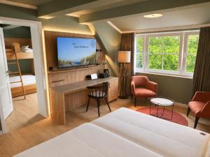 a hotel room with a bed and a tv at Hotel Inselfriede in Spiekeroog +54 photos