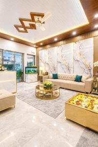 a living room with couches and a table at Hotel Ve Atlantiis Elite in New Delhi
