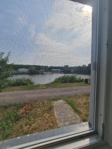 a window with a view of a body of water at Ferma DAC in Galaţi +5 photos