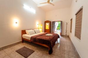 a bedroom with a bed in a room at Chandralayam Heritage Homestay in Bekal +26 photos