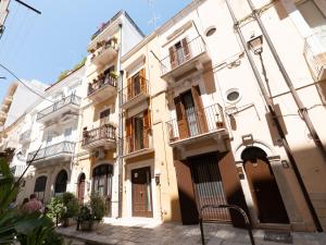 a row of buildings in a street at Dadu 14 in Bari