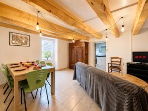a kitchen and dining room with a table and chairs at Triplex Les Vignes in Vérin +20 photos