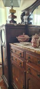an old wooden dresser with a mirror and a dresser at Relais Casa Spanu in Dorgali +223 photos