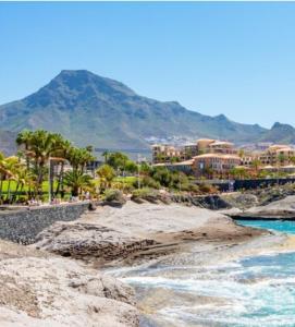 a view of a beach with palm trees and buildings at Cozy loft with Stunning Sea View in Palm-Mar