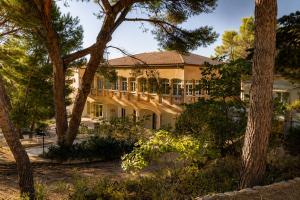 a large house with trees in front of it at Appartements des Joncas in Martigues
