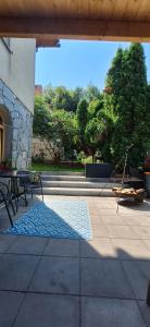 a patio with a bench and a blue rug at Apartamenty Poza Horyzont in Korbielów