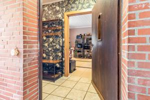 a room with a door and a brick wall at Landleben 2 in Erkelenz +22 photos