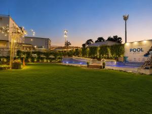 a park with a bench in front of a building at Ravira Resort in Sītāpur