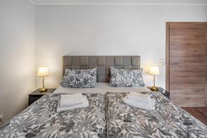 a bedroom with a large bed with two lamps at Landleben 2 in Erkelenz