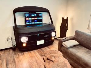 a living room with a couch and a large truck at unique Ferienwohnung in Leutkirch im Allgäu