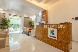 a reception area of a hospital with a reception desk at Treebo Premium The Maulshri, Behind Health Vistaar City in Lucknow