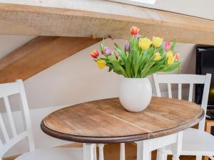 a vase of flowers sitting on a wooden table at Shepherd's Loft in Benson
