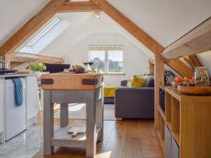 a kitchen with a table in the middle of a room at Shepherd's Loft in Benson