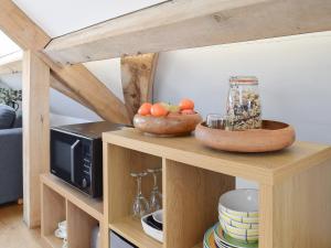a microwave and a bowl of fruit on a shelf at Shepherd's Loft in Benson