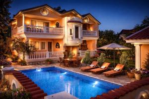 a house with a swimming pool in front of a house at Dalyan Palace in Dalyan