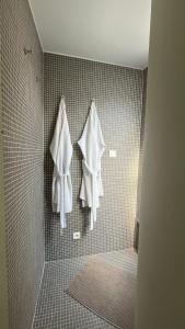 a bathroom with two towels hanging on a wall at Chambreplus Kriski in Ghent +41 photos