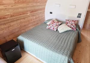 a bed in a room with two pillows on it at Botte dei Benandanti in Vivaro +11 photos