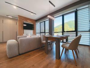 a living room with a couch and a table and chairs at Synyogora in Yaremche