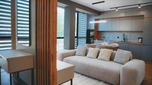 a living room with a couch and a kitchen at Synyogora in Yaremche