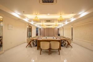 a conference room with a long table and chairs at Treebo Premium The Maulshri, Behind Health Vistaar City in Lucknow