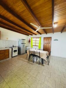 a kitchen with a table and chairs in a room at Atardecer Cabaña frente al rio in Ituzaingó