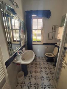 a bathroom with a sink and a toilet at Villino Arsella in Marina di Pietrasanta +15 photos